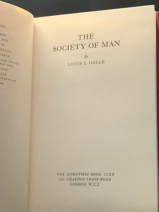 Red book titled 'The Society of Man' by Louis J. Halle on a dark background