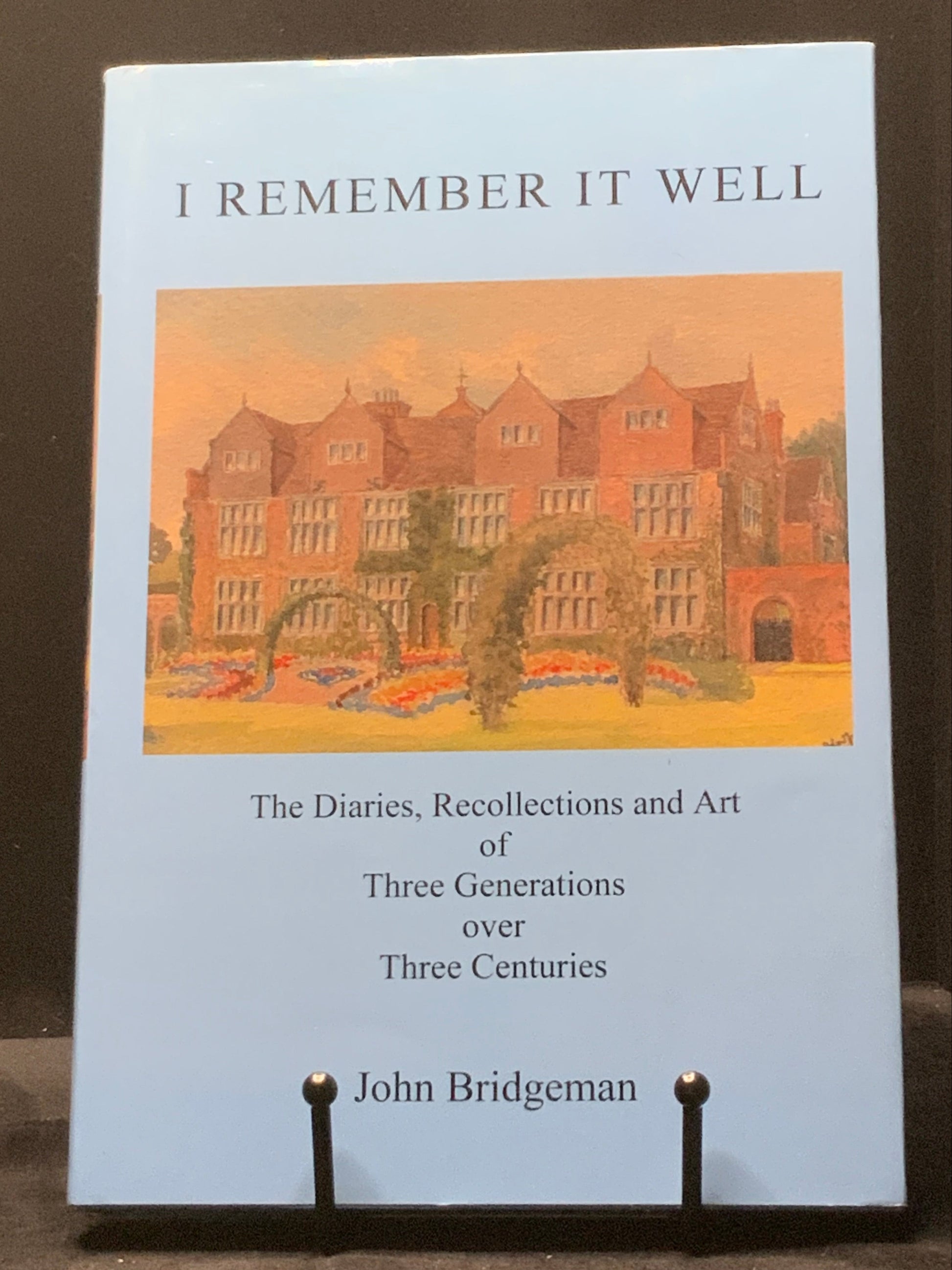 Book titled 'I Remember It Well' by John Bridgeman on a dark surface