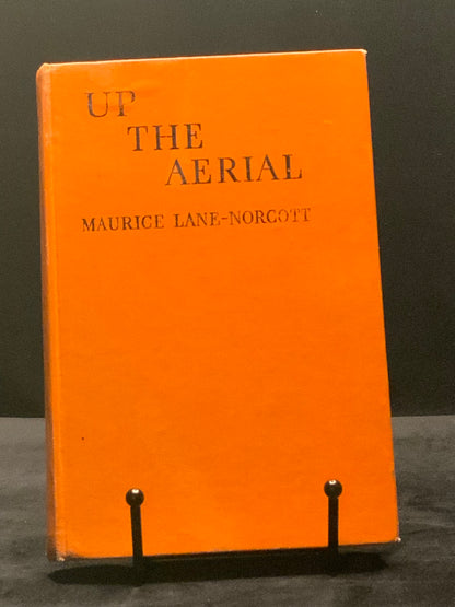 Orange book titled 'Up the Aerial' by Maurice Lane Norcotte on a dark background